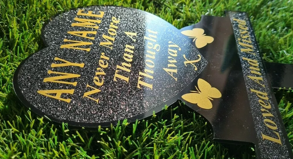 Heart-shaped memorial plaque with remembrance lettering.