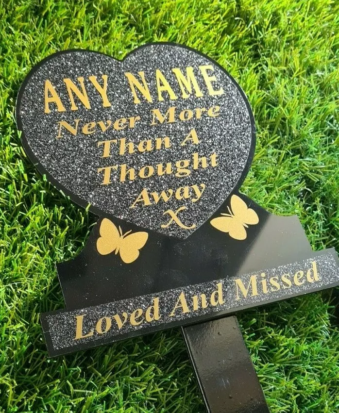 Heart-shaped memorial plaque with remembrance lettering.