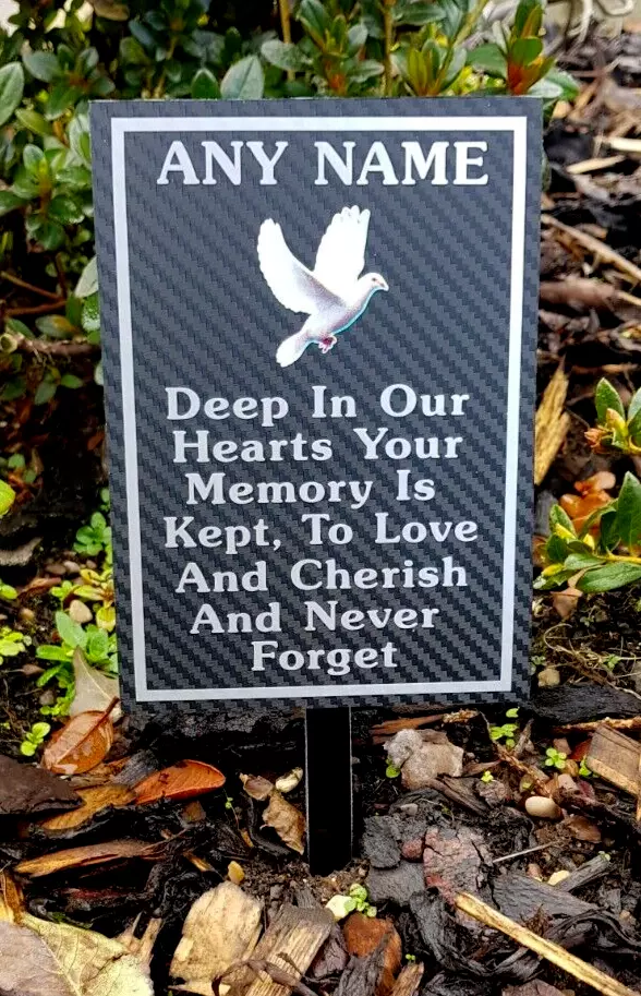 Rectangular memorial plaque with remembrance lettering and a ground stake.