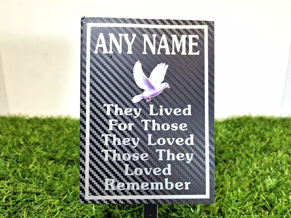 Rectangular memorial plaque with remembrance lettering and a ground stake.