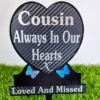 Heart-shaped cousin memorial plaque on grave, engraved with name and dates