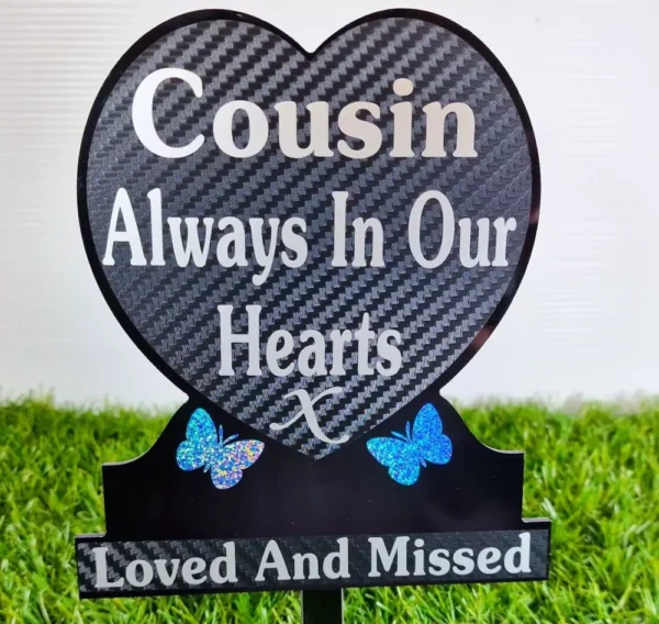 Heart-shaped cousin memorial plaque on grave, engraved with name and dates