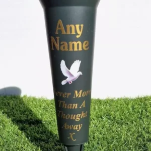Personalised dark green memorial flower vase with engraved name on a cemetery grave