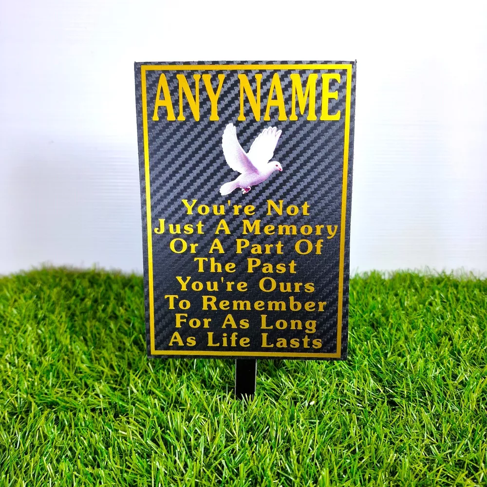 Rectangular memorial plaque with remembrance lettering and a ground stake.