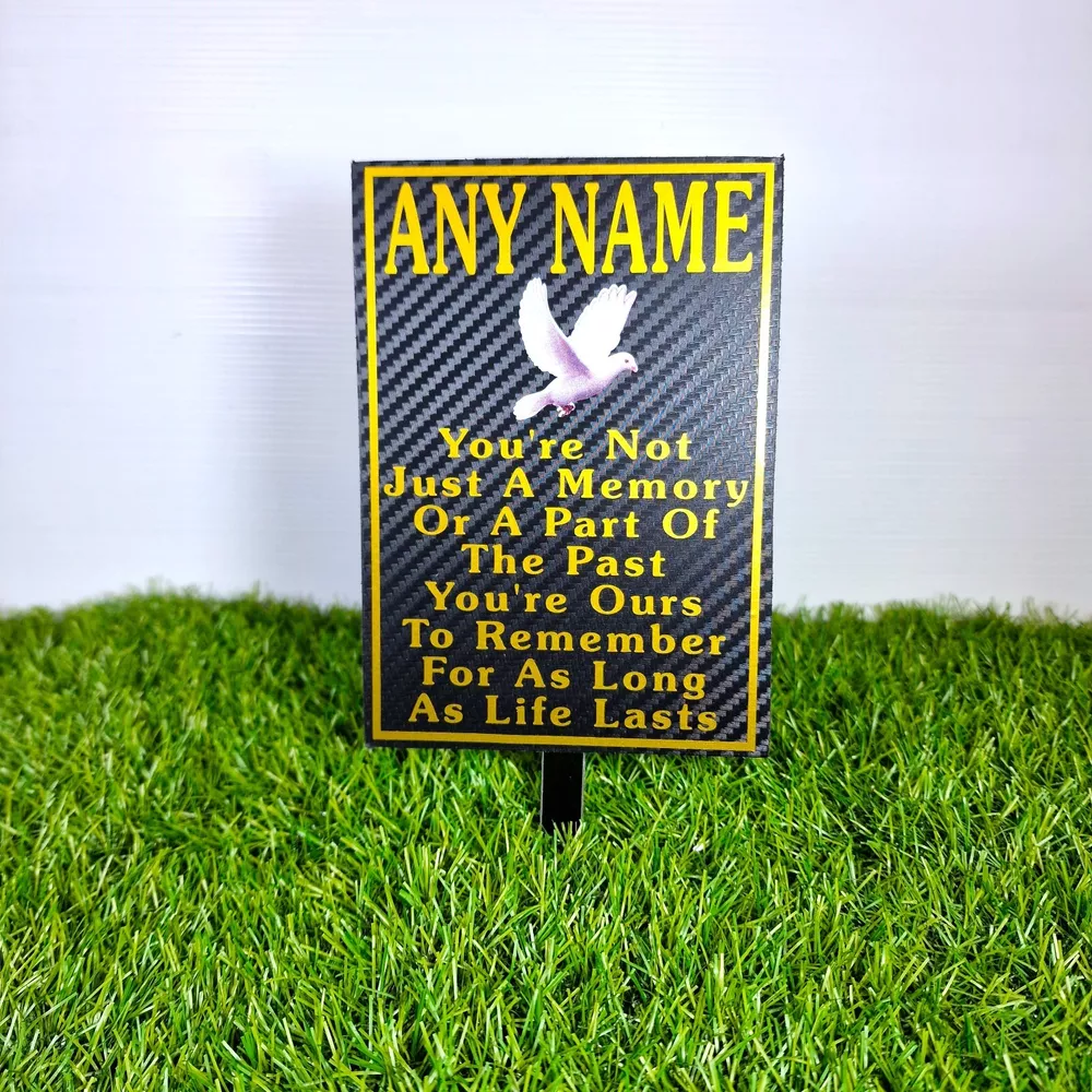Rectangular memorial plaque with remembrance lettering and a ground stake.