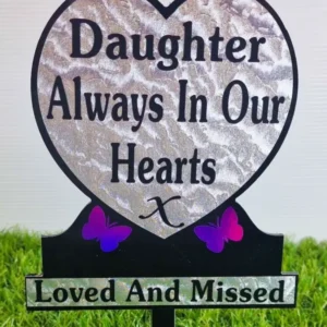 Heart-shaped daughter memorial plaque with purple butterfly on grave