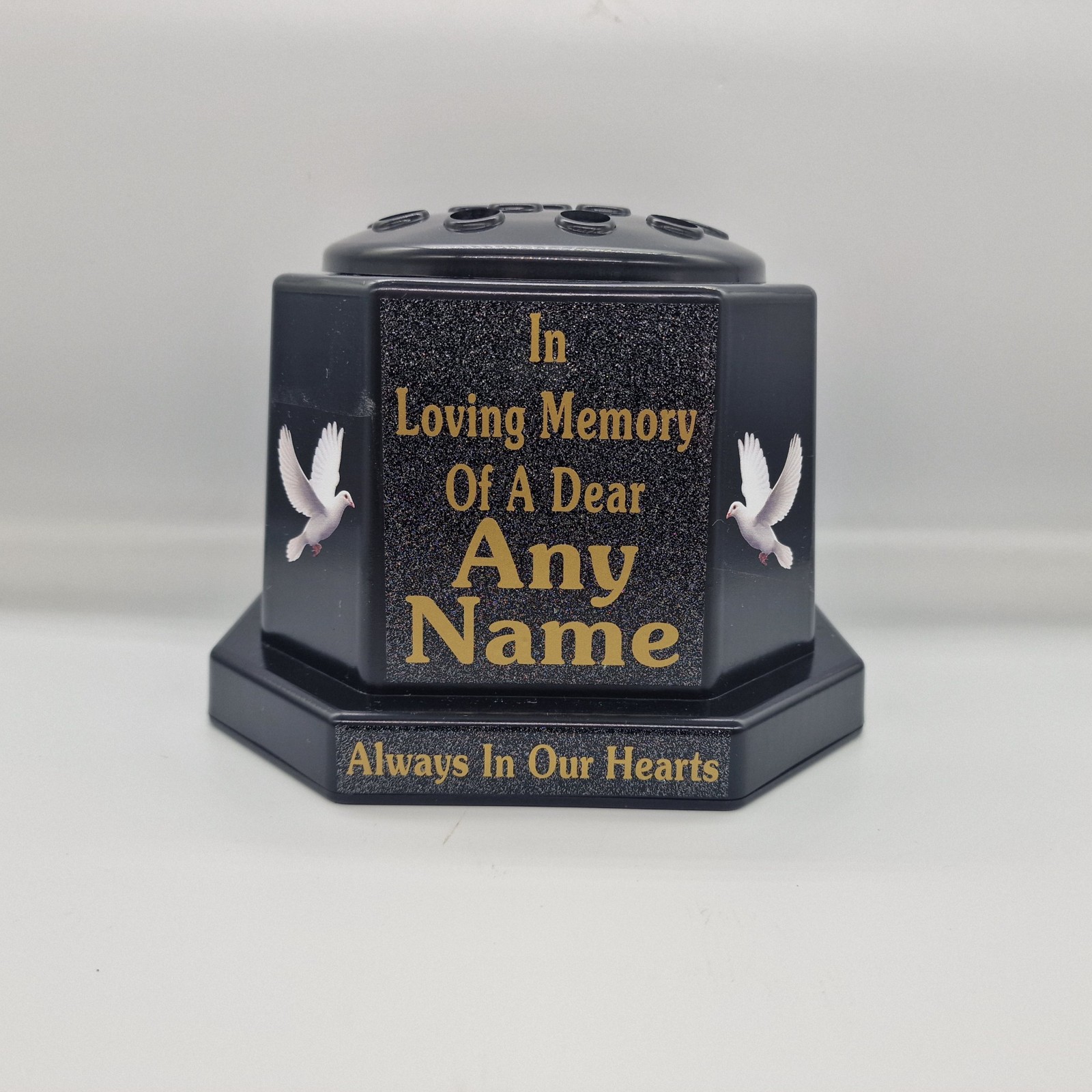 Black memorial rose bowl with white doves, a black flower insert lid and gold name and remembrance lettering.