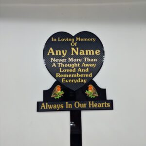 Black heart-shaped memorial plaque with gold name and remembrance lettering, two robin illustrations and a ground stake.